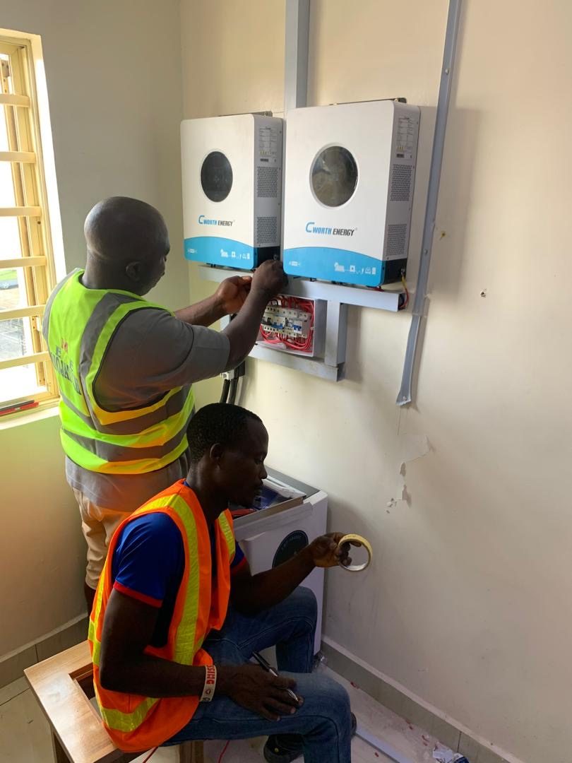MOJATECH technicians mounting and wiring inverters in Ikorodu